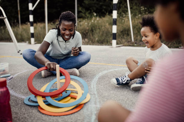 istock Mother with children playing ring toss game 1249001505