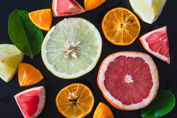 istock Fresh citrus slices on black background. 1249002176