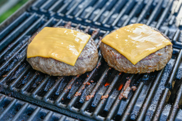 istock two cheese burgers on a warm grill 1249002394