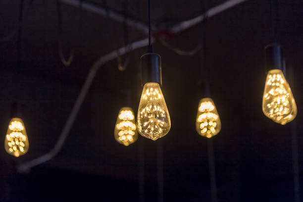 istock A glowing vintage LED incandescent lamp bulbs on the dark background. 1249002534