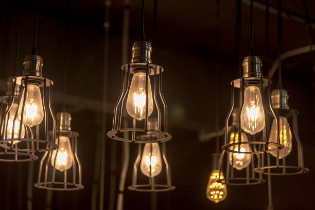 istock Antique/edison-style lighting decoration, vintage ceiling light on dark background. 1249002541