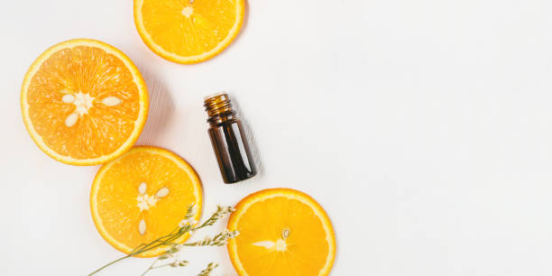istock Bottle of orange essential oil on white background 1249002613
