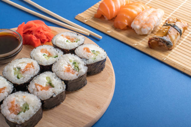 композиция с вкусными суши нигири и роллами - chopsticks soybean japanese cuisine blue стоковые фото и изображения