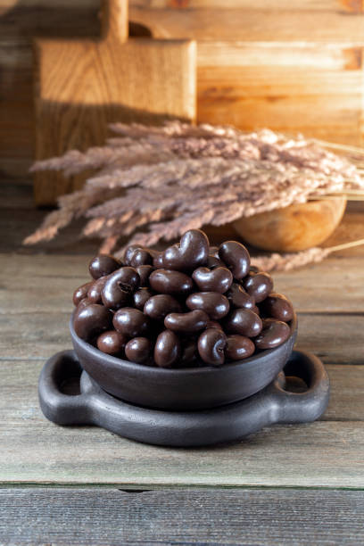 Cashew nuts in chocolate glaze in round bowl