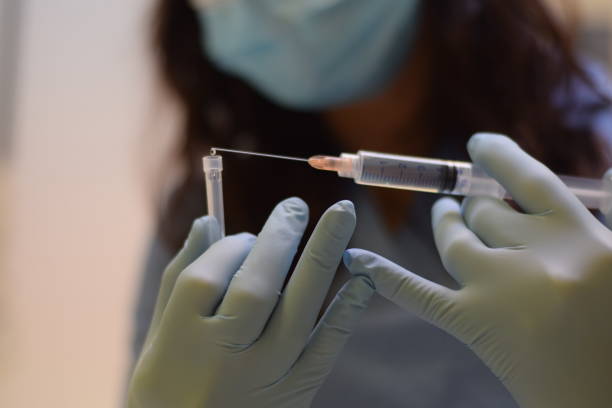 istock A female doctor holding a syringe 1249005845