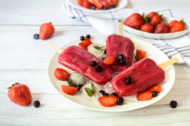 istock fruit ice lolly, made from fresh strawberry and blackcurrant 1249007374