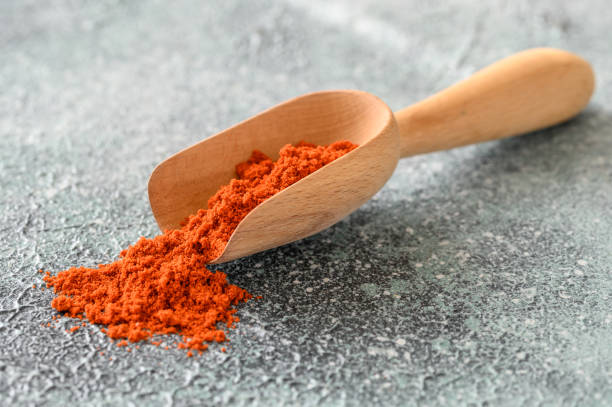 Red paprika Red paprika in wooden scoop close-up cayenne powder photos stock pictures, royalty-free photos & images