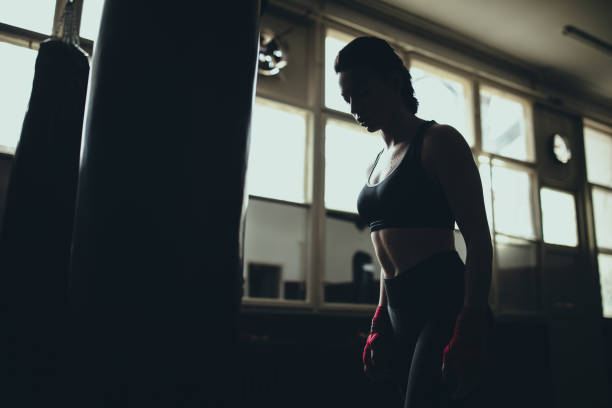 istock Female boxer standing in gym 1249008334