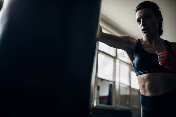 istock Female boxer training in gym 1249008398