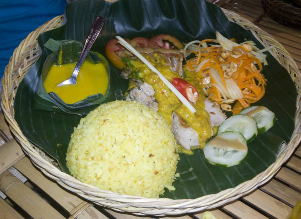istock Balinese dish on a plate with banana leaf - rice with fish and vegetables 1249008431