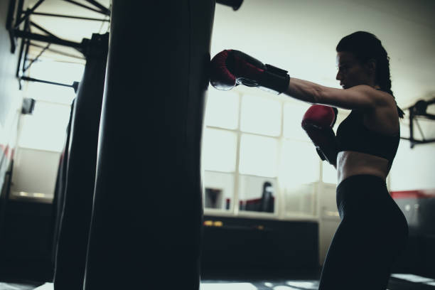 istock Female boxer training alone in gym 1249008793