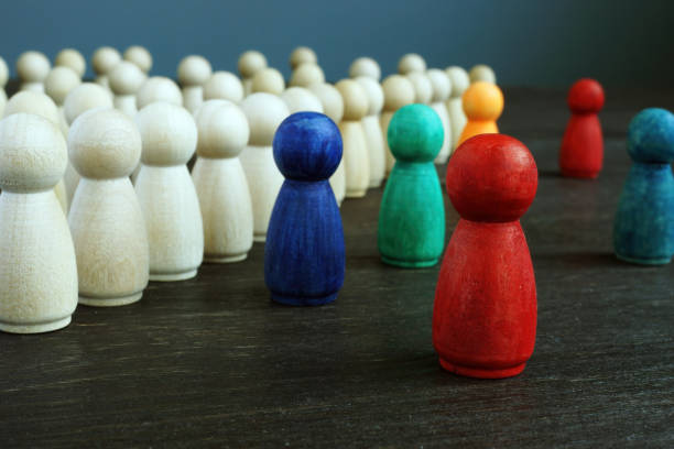 Inclusive and discrimination concept. Lines of wooden figurines and different ones as symbol of diversity. Inclusive and discrimination concept. Lines of wooden figurines and different ones as symbol of diversity. social justice concept photos stock pictures, royalty-free photos & images