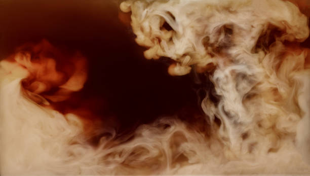 Closeup mixing of milk with coffee Closeup process of making latte, cappuccino, pouring milk, cream into transparent glass cup with coffee. Abstract brown background with light stains. Mixing of liquids. Hot caffeine drinks concept. texture cafe stock pictures, royalty-free photos & images