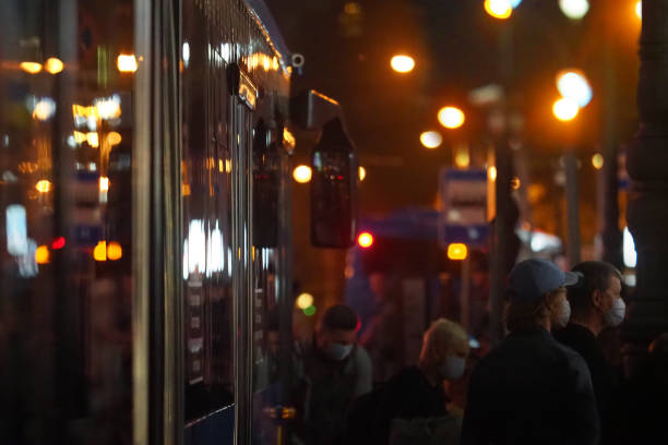 Life during quarantine. Tired people from emergency services return home from work by public transport at night