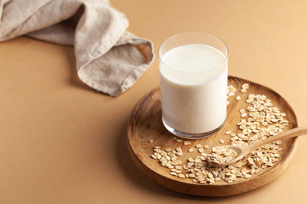 Vegan oat milk, non dairy alternative milk in a glass. Vegan non dairy alternative milk. Oat flakes milk. Copy space Vegan oat milk, non dairy alternative milk in a glass. Vegan non dairy alternative milk. Oat flakes milk. Copy space. High quality photo nature russia environmental conservation mineral stock pictures, royalty-free photos & images