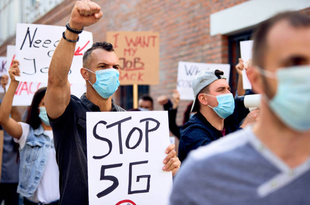 istock Crowd of people protesting against setting up 5G network around the world. 1249018641