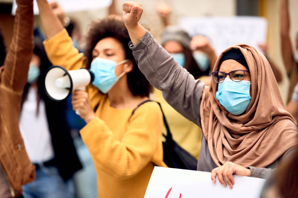 istock Muslim woman wearing protective face mask while being on a protest against racial discrimination. 1249019211