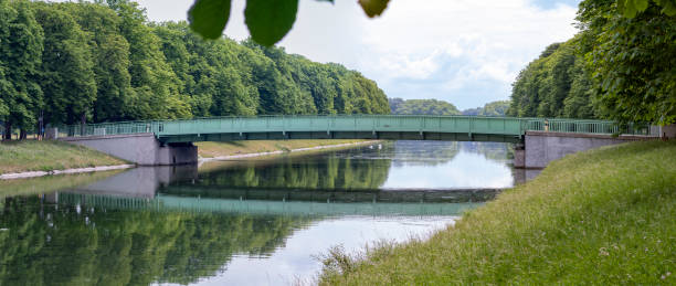 istock green metal bridge at a lake in Cologne, Decksteiner Weiher, cloudy day 1249019455