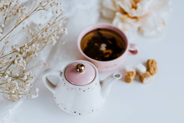 istock Tea set, teapot with sugar cubes and a cup with brewed tea. 1249019502