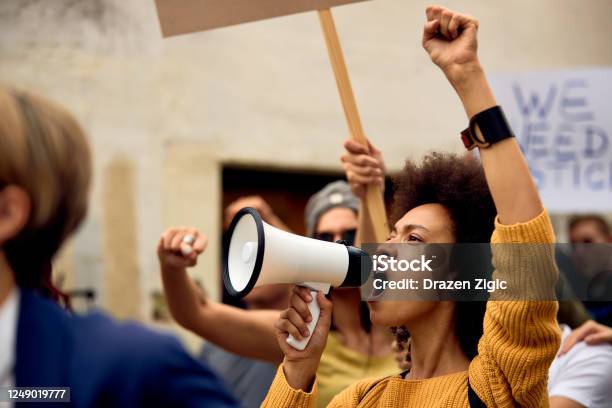 Yung Black Woman Shouting Through Megaphone On Antiracism Demonstrations Stock Photo - Download Image Now