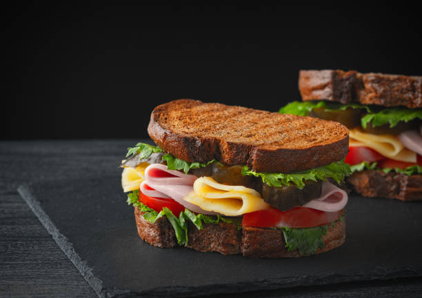 istock Sandwich with ham, cheese, tomatoes, lettuce, and toasted bread. 1249020619