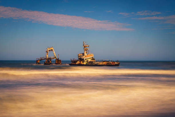 Abandoned shipwreck of the stranded Zeila vessel at the Skeleton Coast, Namibia Abandoned shipwreck of the stranded Zeila vessel at the Skeleton Coast near Swakopmund in Namibia, Africa, with many cormorants sitting on the wreck. Long exposure. swakopmund photos stock pictures, royalty-free photos & images