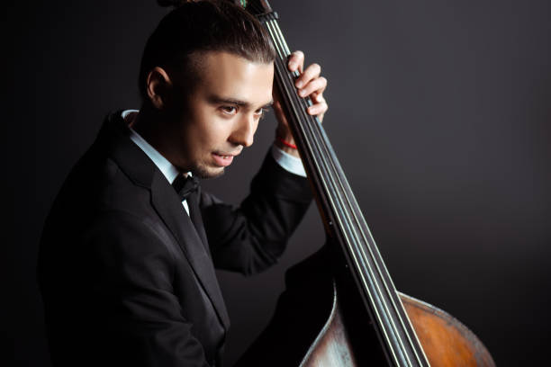 istock young professional musician playing on double bass on dark stage 1249020948