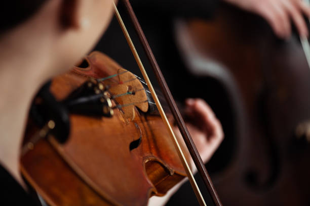 istock cropped view of professional musicians playing on musical instruments on dark stage, selective focus 1249020951