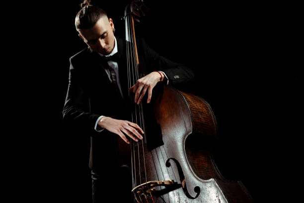 istock male musician playing on contrabass isolated on black 1249020976