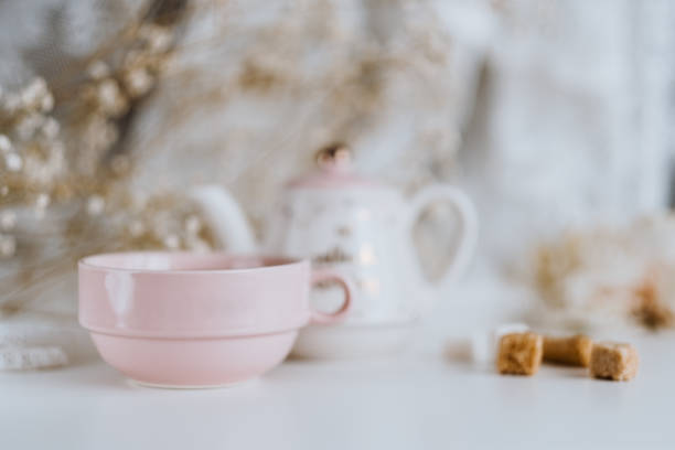 istock Tea set, teapot with sugar cubes and a cup with brewed tea. 1249024173