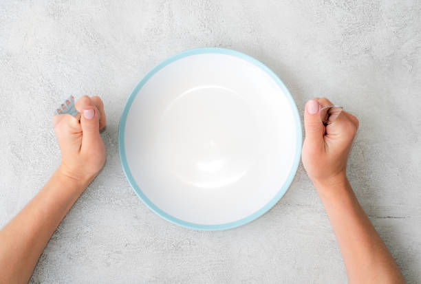 istock Girl holding fork and knife 1249025257