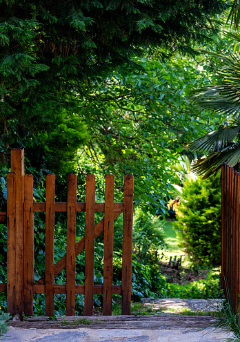 Brown wooden door at the entrance to the garden