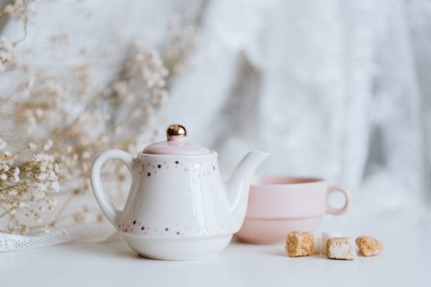 istock Tea set, teapot with sugar cubes and a cup with brewed tea. 1249027126