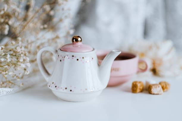 istock Tea set, teapot with sugar cubes and a cup with brewed tea. 1249027175
