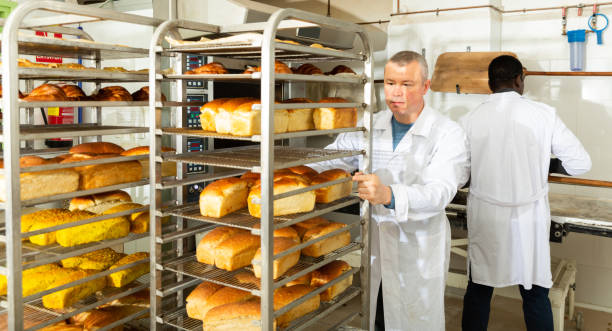 istock Baker carrying fresh bread on trolley 1249027807