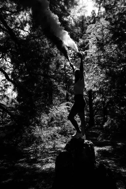 Person Holding Smokebombs in Forest