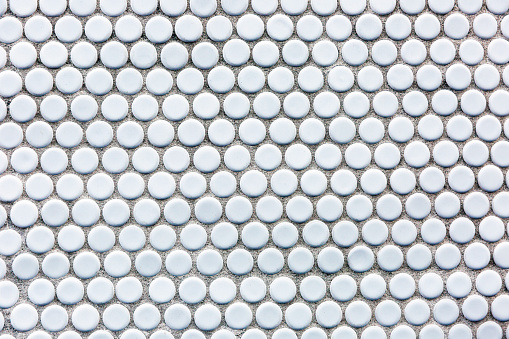 Closeup tiles dot pattern, abstract background with copy space, full frame horizontal composition