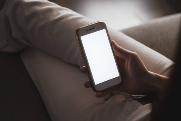 istock Woman uses a smartphone with a white screen. 1249037299