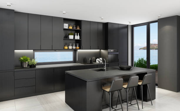 istock Luxurious matte black kitchen with island table at seaside background 1249038830
