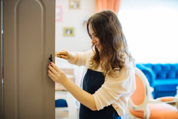 istock Woman Assembling Wooden Cabinet in Home 1249040033