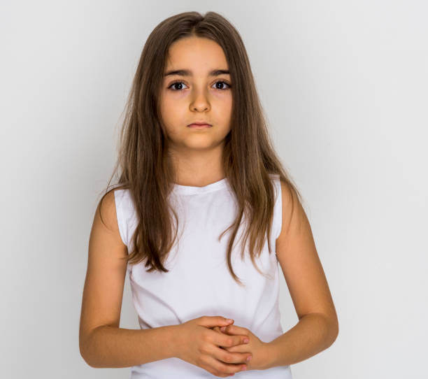 istock Girl put his hands on chest looking sad 1249041537