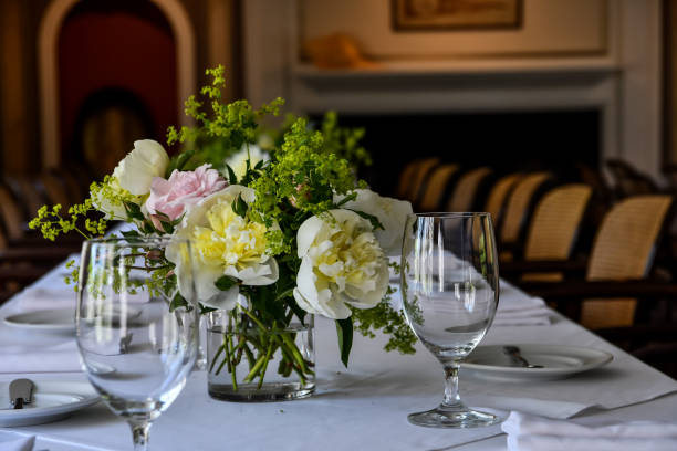 istock Empty water glasses on a table and a vase with flowers 1249046635