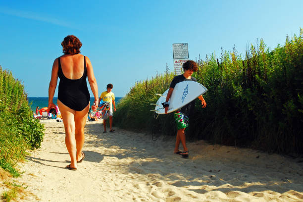 Montauk, NY, USA July 27, 2010 A summer crowd plies a path to and from the beach in Montauk, New York