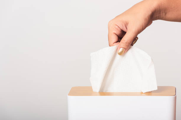 istock Hand taking pulling white facial tissue out of from a white box 1249053807
