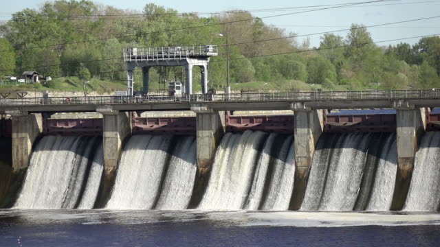 Slow motion of water dam drained from outlet pipe of the dam where is the hydropower electrical generation, Volkhov HYDROELECTRIC POWER station-hydro power station on river Volkhov, Russia,