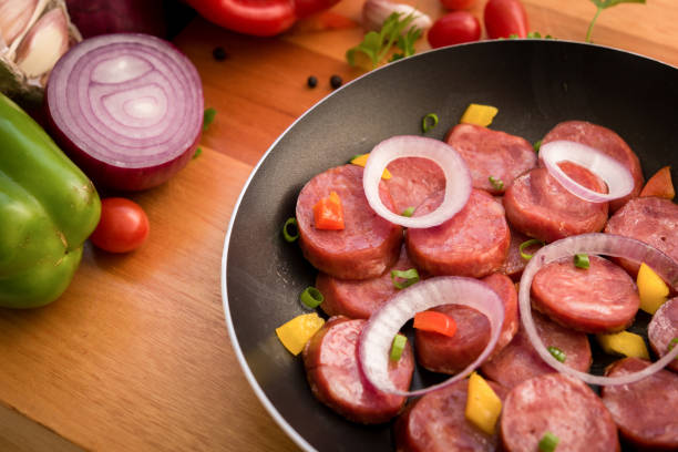 istock Sliced pepperoni with spices in the frying pan. 1249067338