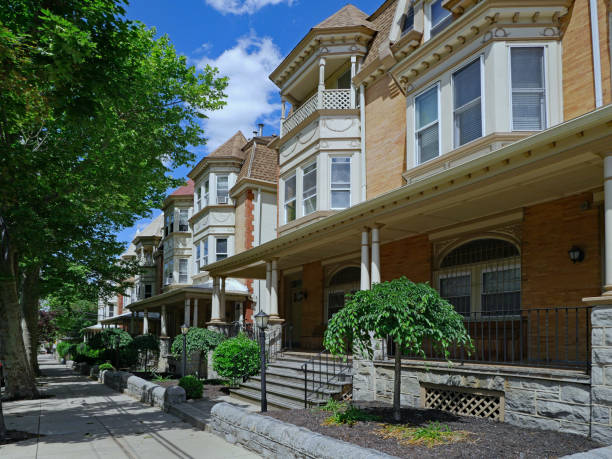 istock Tree-lined street with old fashioned brick houses with large verandas 1249072944