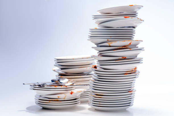 Pile of dirty dishes. Dirty plates, glasses, cutlery on white background. washing dishes photos stock pictures, royalty-free photos & images