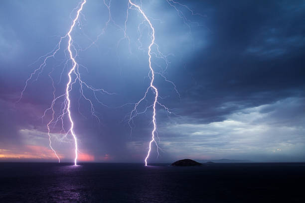 istock Double lightning strike over the ocean at sunset 1249075139
