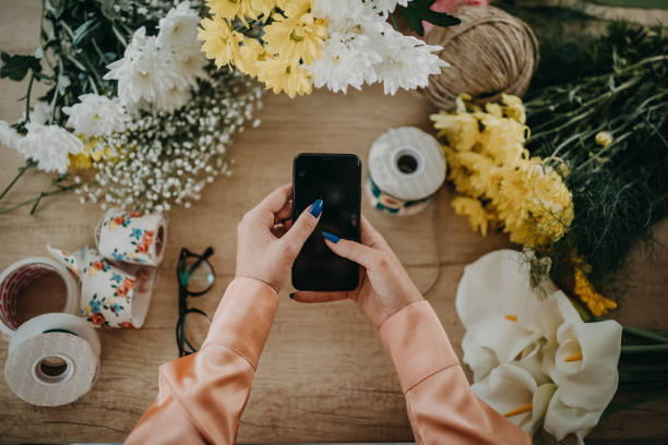 istock Woman photographing her arrangement 1249084100